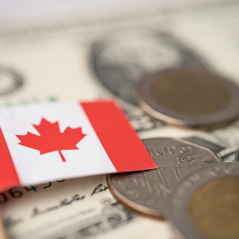Canada flag on coins and banknotes background, finance and accounting, banking concept. Canada flag on coins and banknotes background, finance and accounting, banking concept.