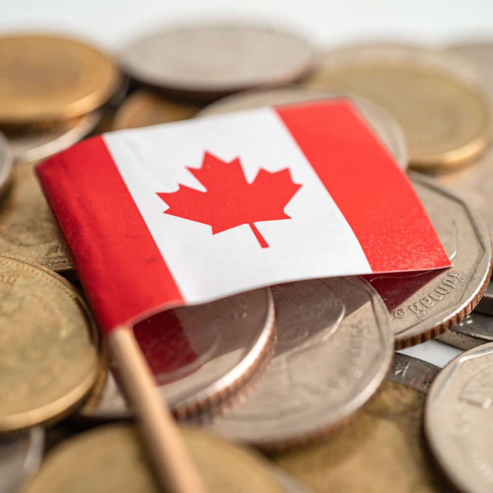 Stack of coins money with Canada flag, finance banking concept.