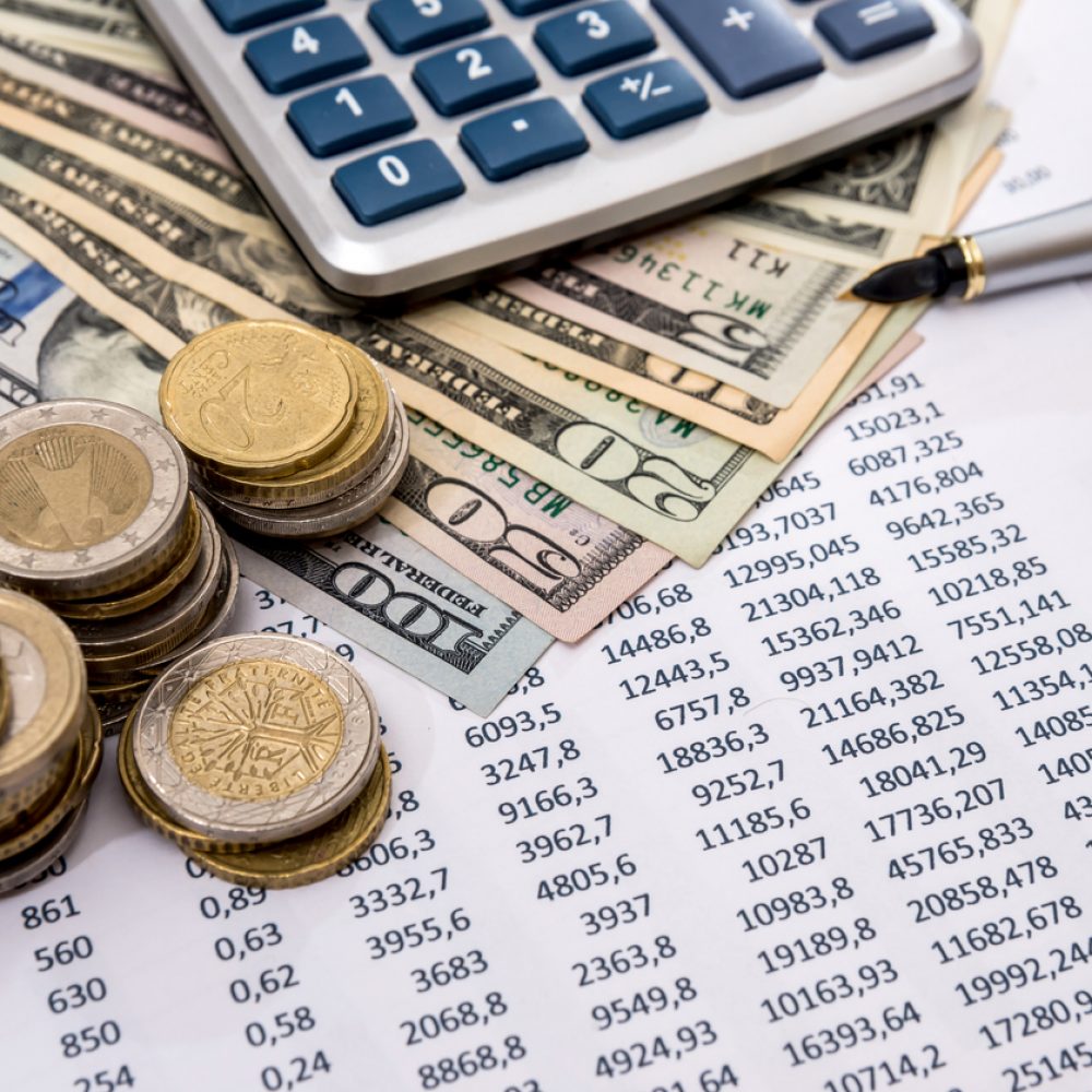 Financial report values with dollars, calculator.